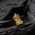 Gold cat-shaped figurine on dark stone surface